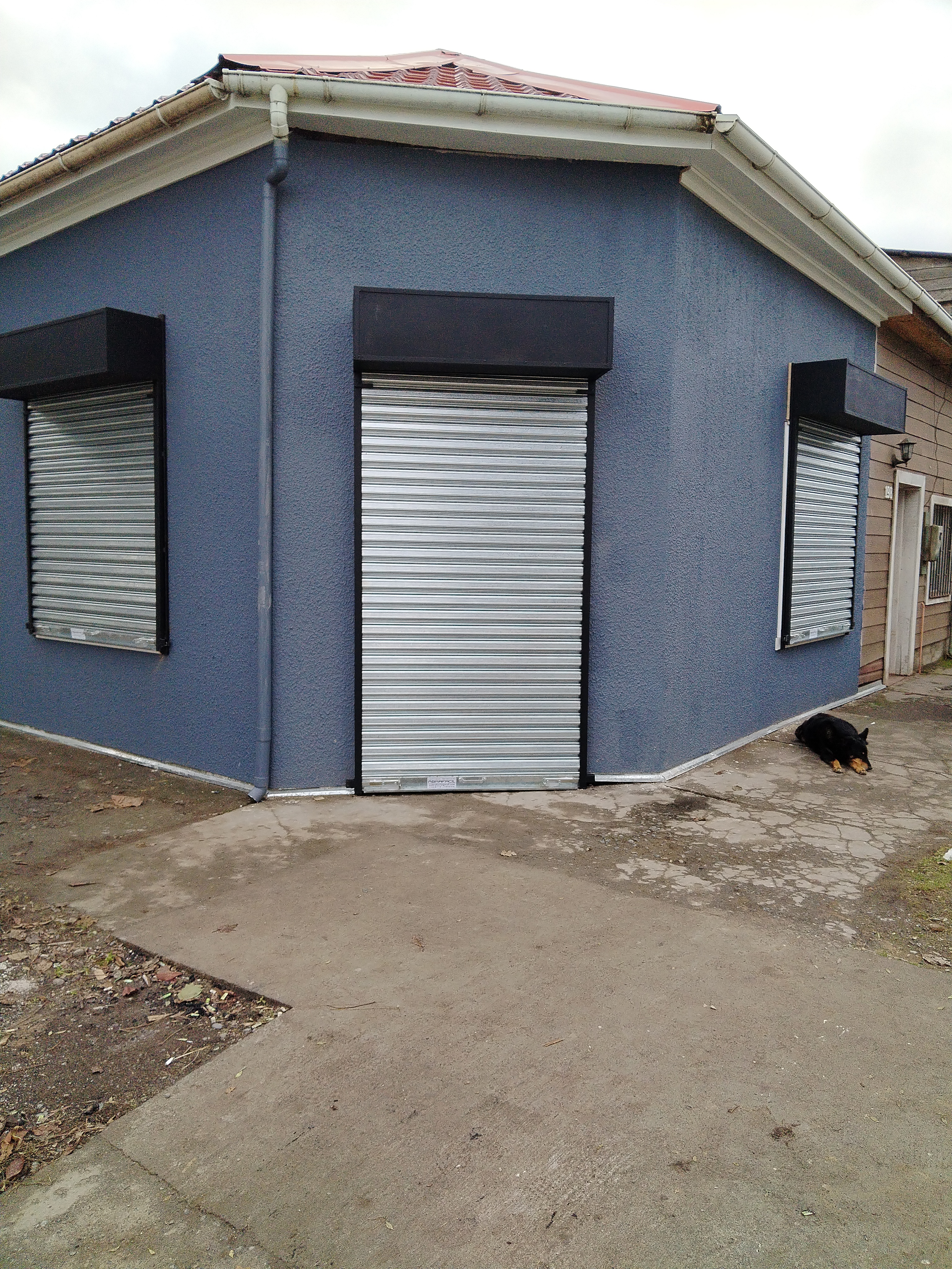 Tres cortinas metálicas instaladas en fachada de local esquina
